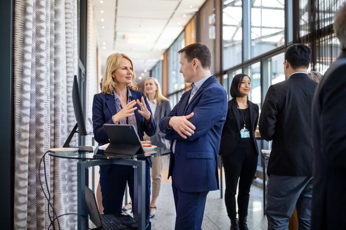Geschäftsleute im Gespräch bei einem Networking-Event in moderner Umgebung