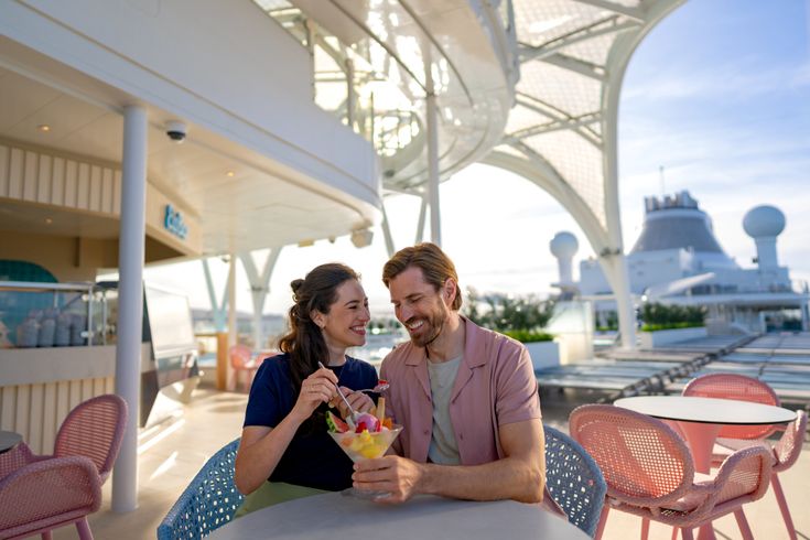 Lachende Gäste sitzen auf dem Deck von Mein Schiff Flow