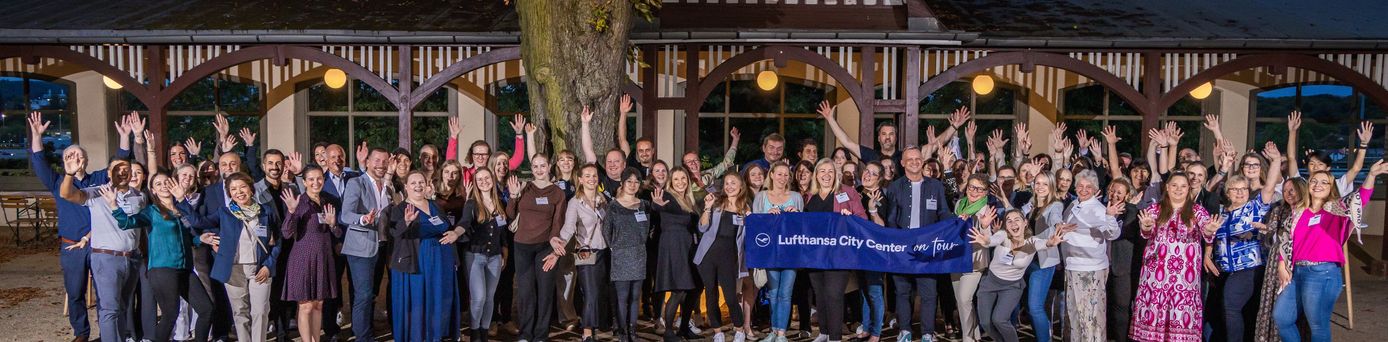 Menschen zum Gruppenbild versammelt bei Tagung von Lufthansa City Center