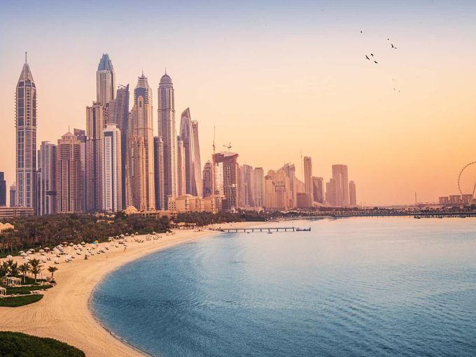 Sonnenuntergangsblick auf die Dubai Marina und das JBR-Gebiet und das berühmte Riesenrad und die goldenen Sandstrände im Persischen Golf.