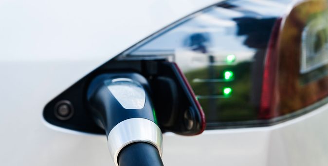 Nahaufnahme eines Elektroautos beim Laden – Symbol für nachhaltige E-Mobilität.