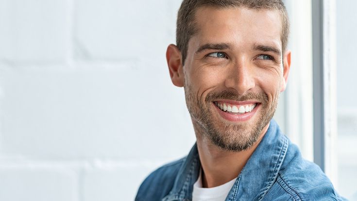 Lachender Mann in Jeanshemd